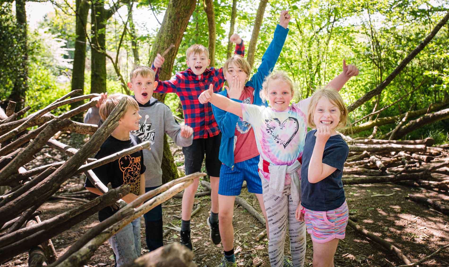 children enjoying shelter building in the Hooke Court woods