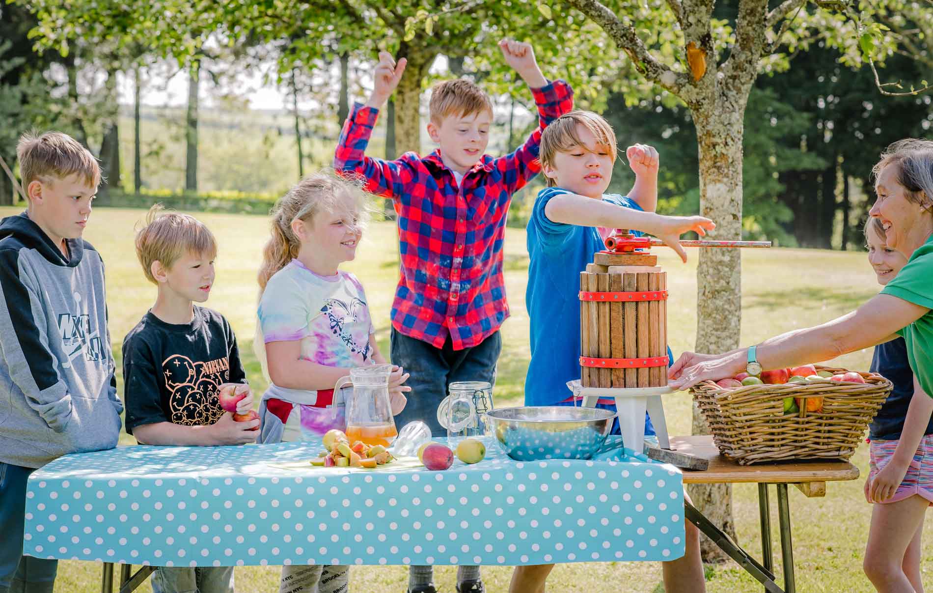 children pressing apple juice