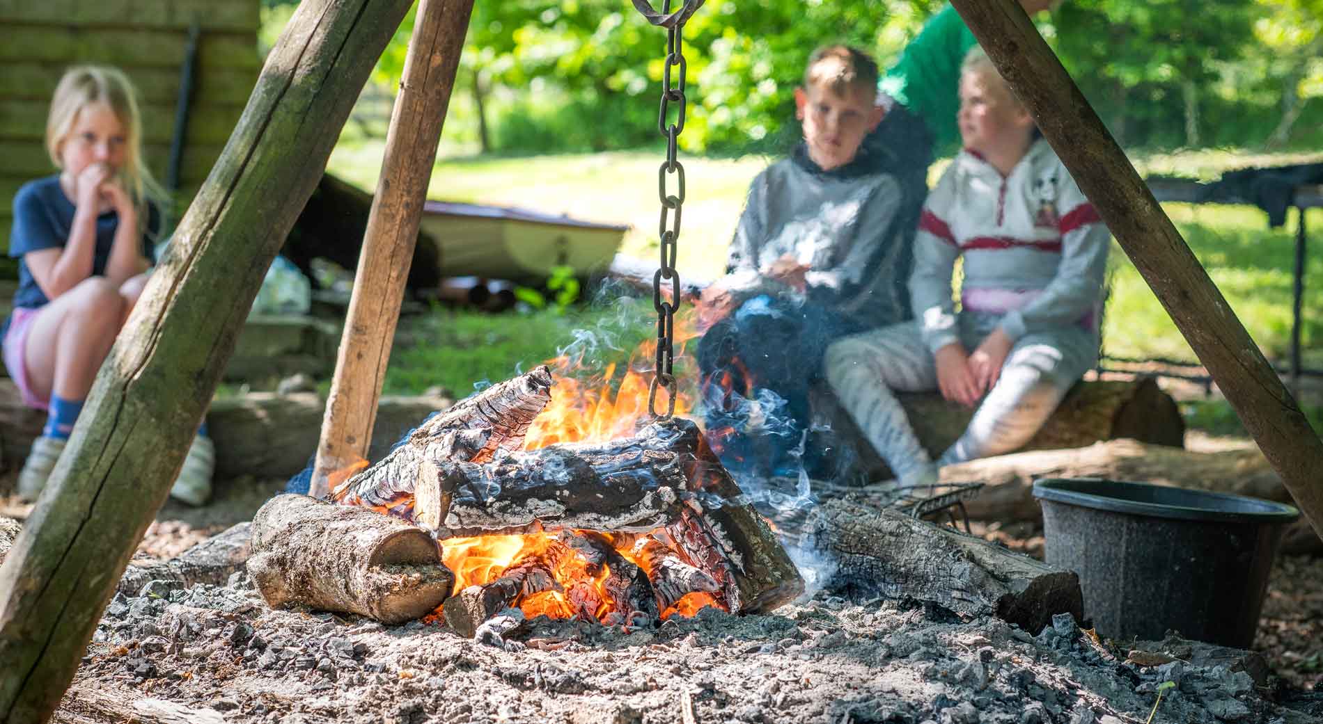 Children sat around an open fire